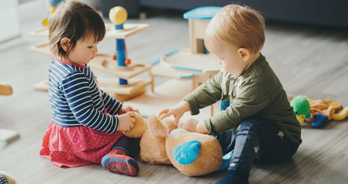 two young toddlers playing together